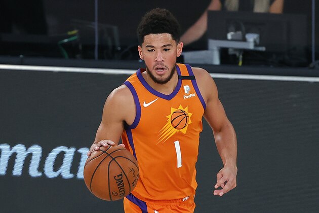 Phoenix Suns' Devin Booker dribbles the ball down court against the Indiana Pacers during the first half of an NBA basketball game Thursday, Aug. 6, 2020, in Lake Buena Vista, Fla. (Kevin C. Cox/Pool Photo via AP)