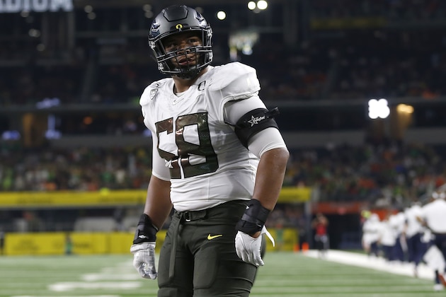 FILE - In this Aug. 31, 2019, file photo, Oregon offensive lineman Penei Sewell (58) looks on as Oregon plays Auburn in an NCAA college football game, in Arlington, Texas. Sewell was selected to The Associated Press All-Pac 12 Conference team, and tied for Offensive Player of the Year with Utah quarterback Tyler Huntley and Utah running back Zack Moss, Thursday, Dec. 12, 2019. (AP Photo/Ron Jenkins, File)