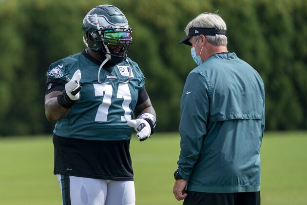 Philadelphia Eagles tackle Jason Peters, left, talks things over with head coach Doug Pederson, right, during an NFL football practice, Sunday, Aug. 23, 2020, in Philadelphia. (AP Photo/Chris Szagola, Pool)