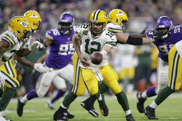 Green Bay Packers quarterback Aaron Rodgers (12) hands the ball off during the second half of an NFL football game against the Minnesota Vikings, Monday, Dec. 23, 2019, in Minneapolis. (AP Photo/Andy Clayton-King)