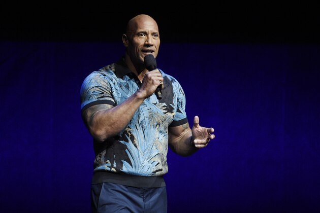 FILE - In this Wednesday, April 3, 2019, file photo, Dwayne Johnson speaks during the Universal Pictures presentation at CinemaCon 2019, the official convention of the National Association of Theatre Owners (NATO) at Caesars Palace, in Las Vegas. Johnson says he and his family tested positive for the coronavirus. Johnson announced their diagnosis in an 11-plus minute video on Instagram on Wednesday, Sept. 2, 2020. (Photo by Chris Pizzello/Invision/AP, File)