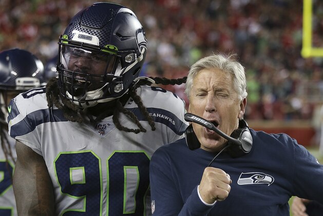 Seattle defensive end Jadeveon Clowney and coach Pete Carroll celebrate a fumble recovery during the Seahawks 26-23 overtime win against the San Francisco 49ers in a NFL football game Monday, Nov. 11, 2019 in Santa Clara, CA. (Daniel Gluskoter/AP Images for Panini)