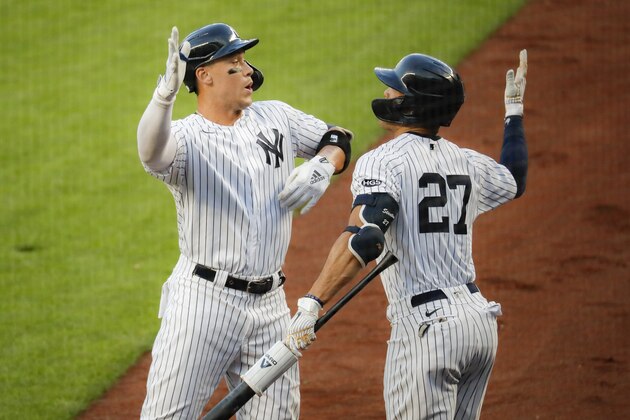 New York Yankees' Aaron Judge, left, celebrates with Giancarlo Stanton, right, after hitting a solo home run off Boston Red Sox starting pitcher Zack Godley in the first inning of a baseball game, Saturday, Aug. 1, 2020, in New York. (AP Photo/John Minchillo)