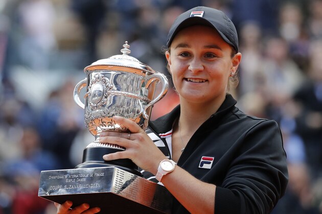 FILE - In this June 8, 2019, file photo, Australia's Ash Barty holds the trophy as she celebrates winning her women's final match of the French Open tennis tournament against Marketa Vondrousova of the Czech Republic in two sets 6-1, 6-3, at the Roland Garros stadium in Paris. Top-ranked Ash Barty has withdrawn from the U.S. Open because she is not comfortable with traveling during the coronavirus pandemic. (AP Photo/Christophe Ena, File)