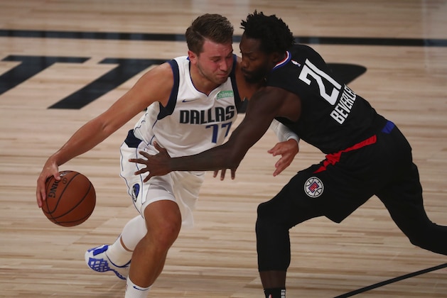 Dallas Mavericks guard Luka Doncic (77) drives against Los Angeles Clippers guard Patrick Beverley (21) in the first half of Game 1 of an NBA basketball first-round playoff series, Monday, Aug. 17, 2020, in Lake Buena Vista, Fla. (Kim Klement/Pool Photo via AP)