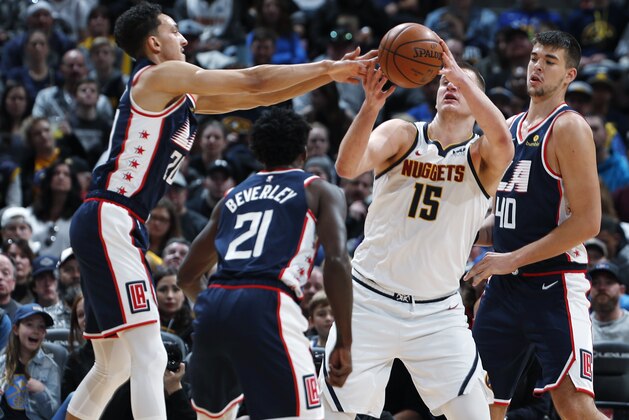 From left to right, Los Angeles Clippers guard Landry Shamet, guard Patrick Beverley, Denver Nuggets center Nikola Jokic and Clippers center Ivica Zubac pursue the ball in the first half of an NBA basketball game Sunday, Feb. 24, 2019, in Denver. (AP Photo/David Zalubowski)