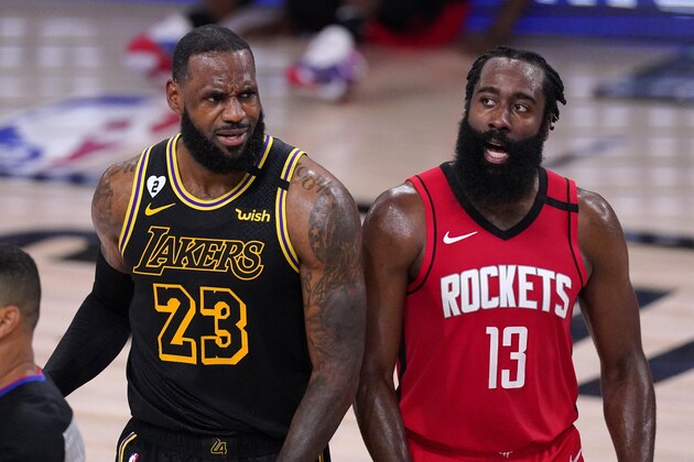 Los Angeles Lakers' LeBron James (23) and Houston Rockets' James Harden (13) react to a call during the second half of an NBA conference semifinal playoff basketball game Sunday, Sept. 6, 2020, in Lake Buena Vista, Fla. (AP Photo/Mark J. Terrill)