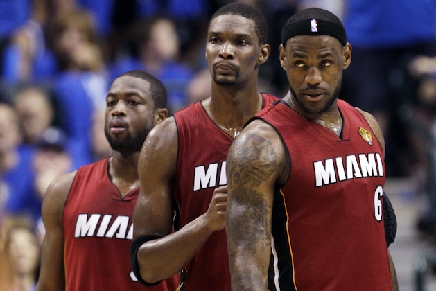 FILE - In this June 7, 2011, file photo, Miami Heat's Dwyane Wade, left, Chris Bosh, center,  and LeBron James (6) look on during a break in the second half of Game 4 of the NBA Finals basketball game in Dallas.  James told Sports Illustrated on Friday, July 11, 2014, he is leaving the Miami Heat to go back to the Cleveland Cavaliers. (AP Photo/David J. Phillip, File)