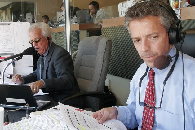 Cincinnati Reds radio broadcasters Marty Brennaman, left, and his son, Thom Brennaman, work in the radio booth during a baseball game against the Chicago Cubs, Monday, April 2, 2007, in Cincinnati. The father and son duo were doing their first regular season broadcast together. (AP Photo/David Kohl)