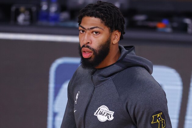 Los Angeles Lakers' Anthony Davis wears a Kobe Bryant patch on his jacket during warmups before Game 4 of an NBA basketball first-round playoff series against the Portland Trail Blazers, Monday, Aug. 24, 2020, in Lake Buena Vista, Fla. (Kevin C. Cox/Pool Photo via AP)