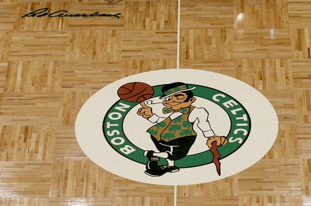 The Boston Celtics logo and Red Auerbach signature are seen on the TD Garden parquet floor before the start of an NBA basketball game, Wednesday, Feb. 27, 2019, in Boston. (AP Photo/Mary Schwalm)