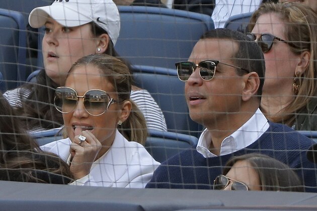 Actress Jennifer Lopez, left, and former major league baseball player Alex Rodriguez watch a baseball game between the New York Yankees and the Baltimore Orioles, Saturday, March 30, 2019, in New York. (AP Photo/Julie Jacobson)