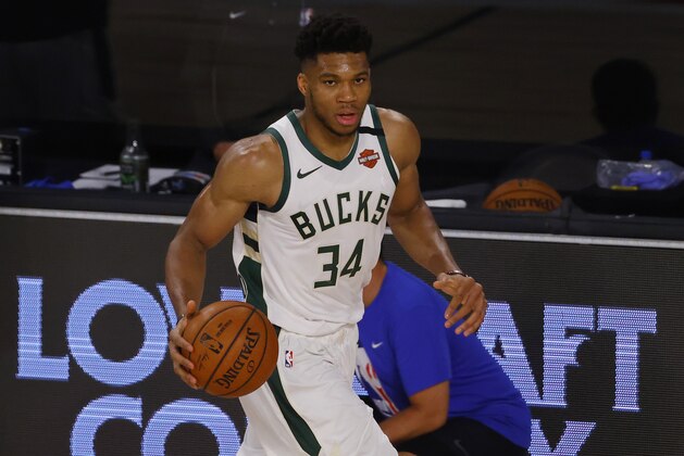 Milwaukee Bucks' Giannis Antetokounmpo (34) moves the ball up court against the Orlando Magic during Game 3 of an NBA basketball first-round playoff series, Saturday, Aug. 22, 2020, in Lake Buena Vista, Fla. (Mike Ehrmann/Pool Photo via AP)