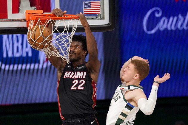 Miami Heat's Jimmy Butler (22) dunks the ball after getting past Milwaukee Bucks' Donte DiVincenzo (0) during the second half of an NBA basketball conference semifinal playoff game, Monday, Aug. 31, 2020, in Lake Buena Vista, Fla. (AP Photo/Mark J. Terrill)