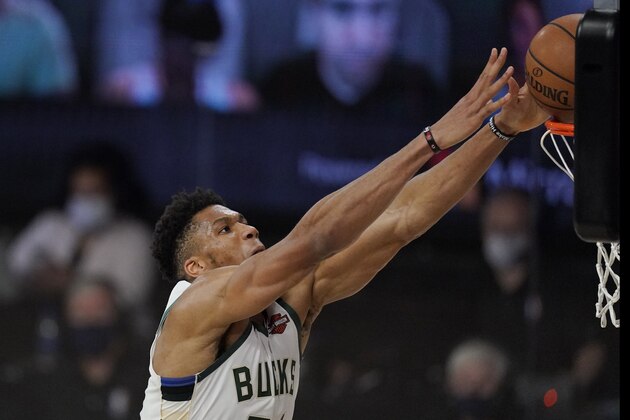 Milwaukee Bucks' Giannis Antetokounmpo dunks in the second half of an NBA conference semifinal playoff basketball game against the Miami Heat Friday, Sept. 4, 2020, in Lake Buena Vista, Fla. (AP Photo/Mark J. Terrill)