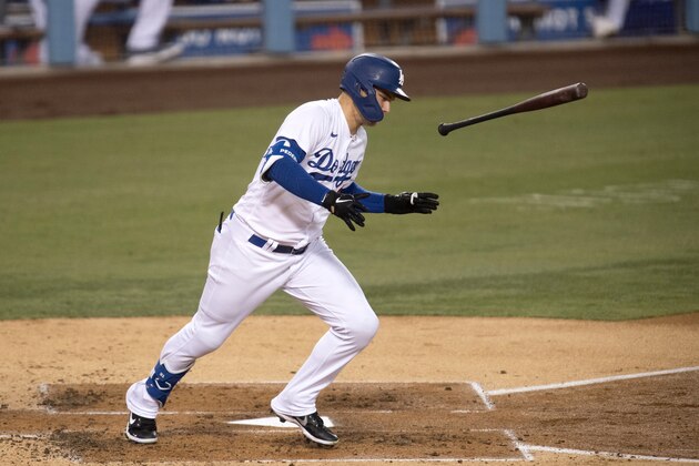 Los Angeles Dodgers' Joc Pederson flips his bat as he hits a ground ball during a baseball game against the Colorado Rockies in Los Angeles, Friday, Sept. 4, 2020. (AP Photo/Kyusung Gong)