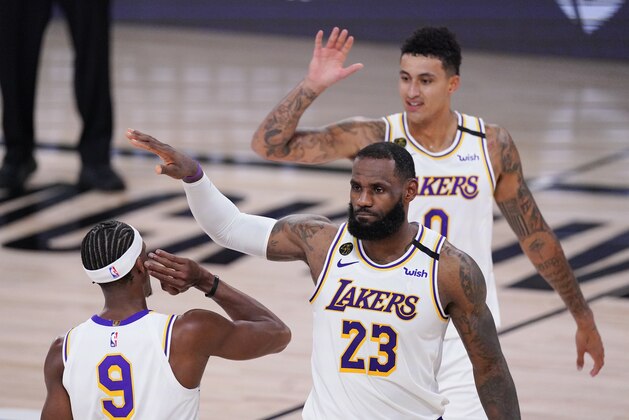 Los Angeles Lakers' LeBron James, Kyle Kuzma, rear, and Rajon Rondo (9) celebrate during the second half of an NBA conference semifinal playoff basketball game against the Houston Rockets Tuesday, Sept. 8, 2020, in Lake Buena Vista, Fla. (AP Photo/Mark J. Terrill)