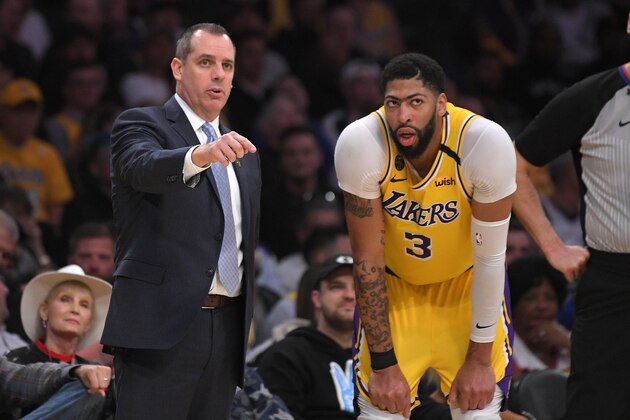 Los Angeles Lakers head coach Frank Vogel, left, talks with forward Anthony Davis during the first half of an NBA basketball game against the Philadelphia 76ers Tuesday, March 3, 2020, in Los Angeles. (AP Photo/Mark J. Terrill)