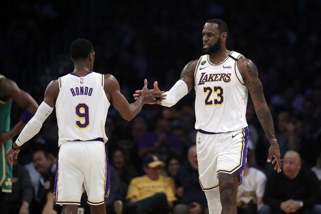 Los Angeles Lakers' LeBron James (23) shakes hands with Rajon Rondo during the first half of an NBA basketball game against the Boston Celtics Sunday, Feb. 23, 2020, in Los Angeles. (AP Photo/Marcio Jose Sanchez)