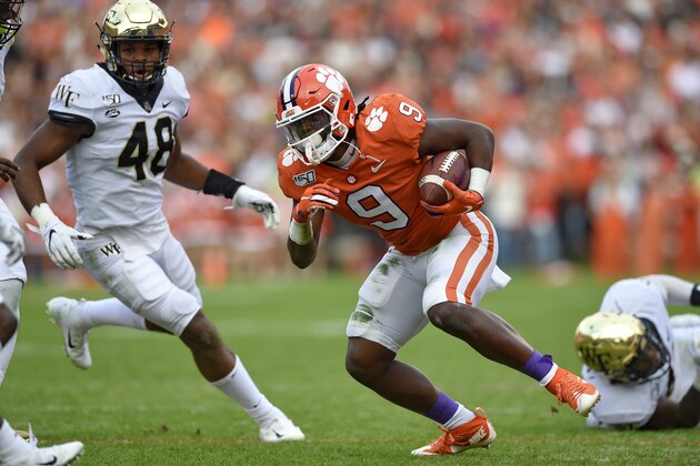 Clemson's Travis Etienne (9) rushes while defended by Wake Forest's Chase Jones during the first half of an NCAA college football game Saturday, Nov. 16, 2019, in Clemson, S.C. (AP Photo/Richard Shiro)