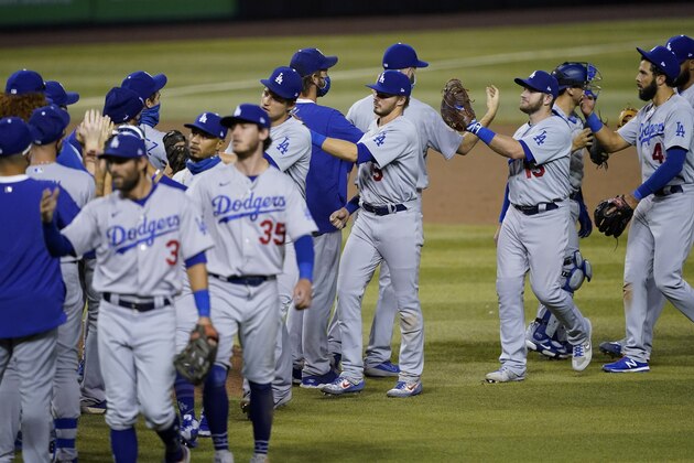 The Los Angeles Dodgers celebrate after a baseball game against the Arizona Diamondbacks, Tuesday, Sept. 8, 2020, in Phoenix. The Dodgers won 10-9 in 10 innings. (AP Photo/Matt York)