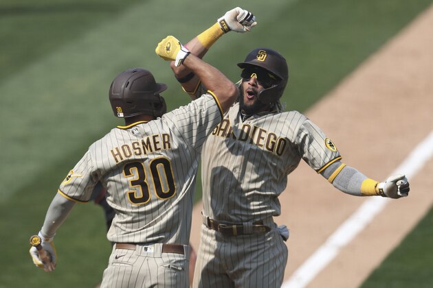 San Diego Padres' Fernando Tatis Jr celebrates after hitting a solo home run against the Oakland Athletics with teammate Eric Hosmer during the seventh inning of a baseball game in Oakland, Calif., Sunday, Sept. 6, 2020. (AP Photo/Jed Jacobsohn)