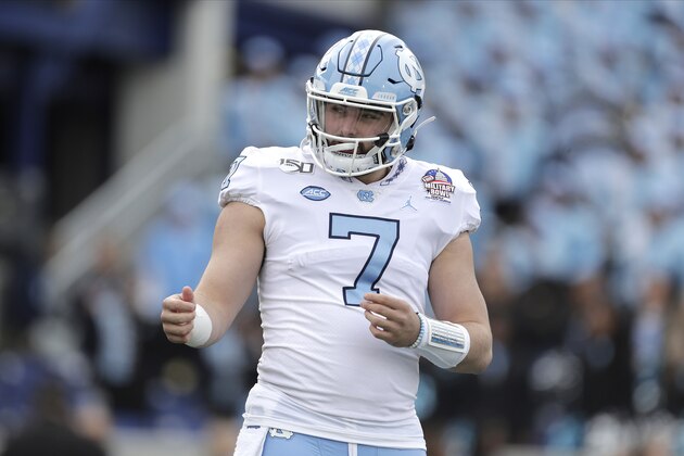 North Carolina quarterback Sam Howell talks to a teammate during the first half of the Military Bowl NCAA college football game against Temple, Friday, Dec. 27, 2019, in Annapolis, Md. (AP Photo/Julio Cortez)
