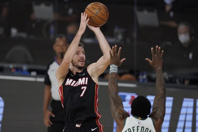 Miami Heat's Goran Dragic (7) shoots over Milwaukee Bucks' Eric Bledsoe, right, in the first half of an NBA conference semifinal playoff basketball game Tuesday, Sept. 8, 2020 in Lake Buena Vista, Fla. (AP Photo/Mark J. Terrill)