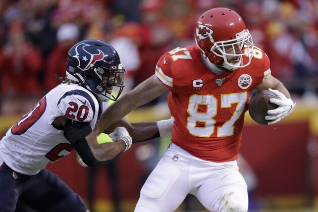FILE - In this Jan. 12, 2020, file photo, Kansas City Chiefs tight end Travis Kelce (87) is tackled by Houston Texans safety Justin Reid during the second half of an NFL divisional playoff football game in Kansas City, Mo. Kelce has two years remaining on a five-year, $46.8 million extension that he signed in 2016. (AP Photo/Charlie Riedel, File)