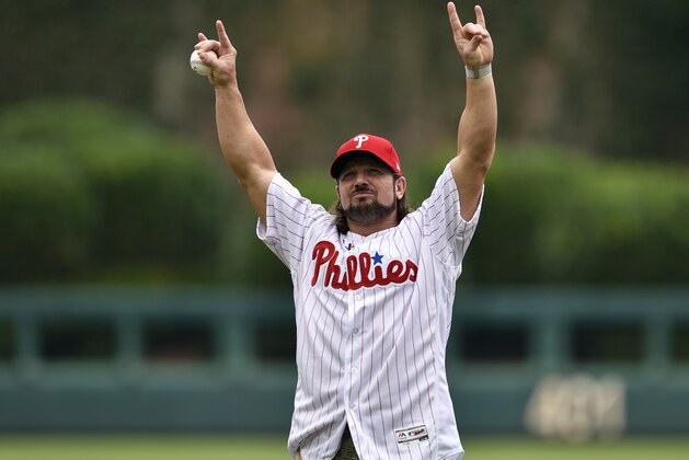 WWE's superstar A.J. Styles throws out the ceremonial opening pitch prior to a baseball game between the Philadelphia Phillies and the Milwaukee Brewers, Sunday, July 23, 2017, in Philadelphia. (AP Photo/Derik Hamilton)