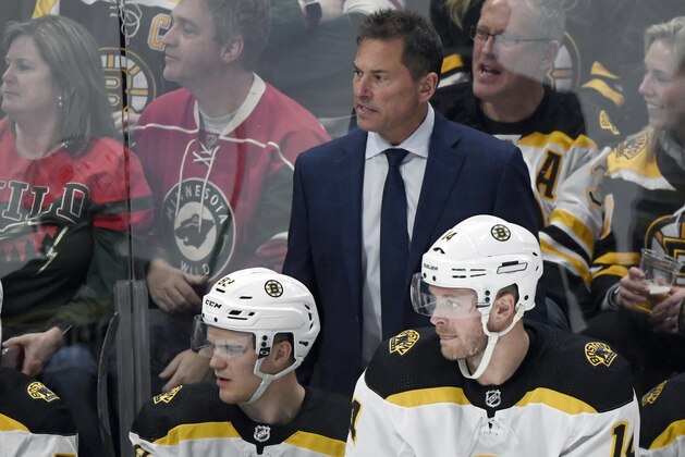 Boston Bruins coach Bruce Cassidy watches play against the Minnesota Wild from the bench with center Karson Kuhlman (83) and right wing Chris Wagner (14) during the third period of an NHL hockey game Saturday, Feb. 1, 2020, in St. Paul, Minn. The Bruins won 6-1. (AP Photo/Hannah Foslien) Boston Bruins coach Bruce Cassidy watches play against the Minnesota Wild from the bench with center Karson Kuhlman (83) and right wing Chris Wagner (14) during the third period of an NHL hockey game Saturday, Feb. 1, 2020, in St. Paul, Minn. The Bruins won 6-1. (AP Photo/Hannah Foslien)