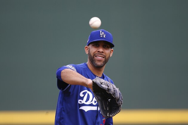 Los Angeles Dodgers starting pitcher David Price gets the baseball back from his catcher as he warms up during the second inning of a spring training baseball game against the Cincinnati Reds Monday, March 2, 2020, in Goodyear, Ariz. (AP Photo/Ross D. Franklin)