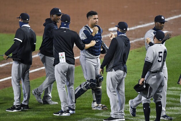 New York Yankees catcher Gary SÃ¡nchez, center, and teammates celebrate a 7-2 win over the Toronto Blue Jays in a baseball game in Buffalo, N.Y., Wednesday, Sept. 9, 2020. (AP Photo/Adrian Kraus)