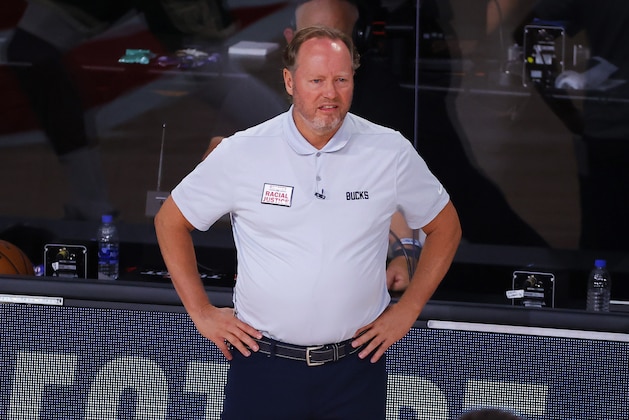Milwaukee Bucks coach Mike Budenholzer watches the team play the Dallas Mavericks during an NBA basketball game Saturday, Aug. 8, 2020, in Lake Buena Vista, Fla. (Kevin C. Cox/Pool Photo via AP)