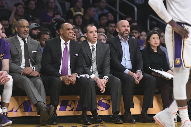 Los Angeles Lakers assistant coaches Phil Handy, Lionel Hollins, head coach Frank Vogel, assistant coach Jason Kidd and trainer Nina Hsieh, from left, during an NBA basketball game against the Dallas Mavericks Sunday, Dec. 29, 2019, in Los Angeles. (AP Photo/Michael Owen Baker)