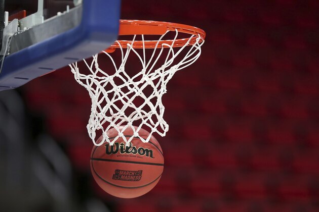 A Wilson basketball goes through the rim during a Cal State Fullerton practice for an NCAA men's college basketball tournament first-round game, Thursday, March 15, 2018, in Detroit. Cal State Fullerton plays Purdue in the first round on Friday. (AP Photo/Carlos Osorio)