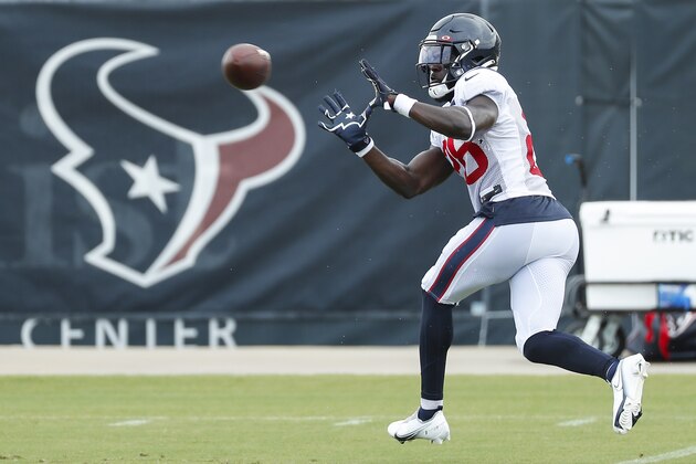 Houston Texans safety Michael Thomas reaches out to make a catch while running a pass coverage drill during an NFL training camp football practice Monday, Aug. 24, 2020, in Houston. (Brett Coomer/Houston Chronicle via AP, Pool)