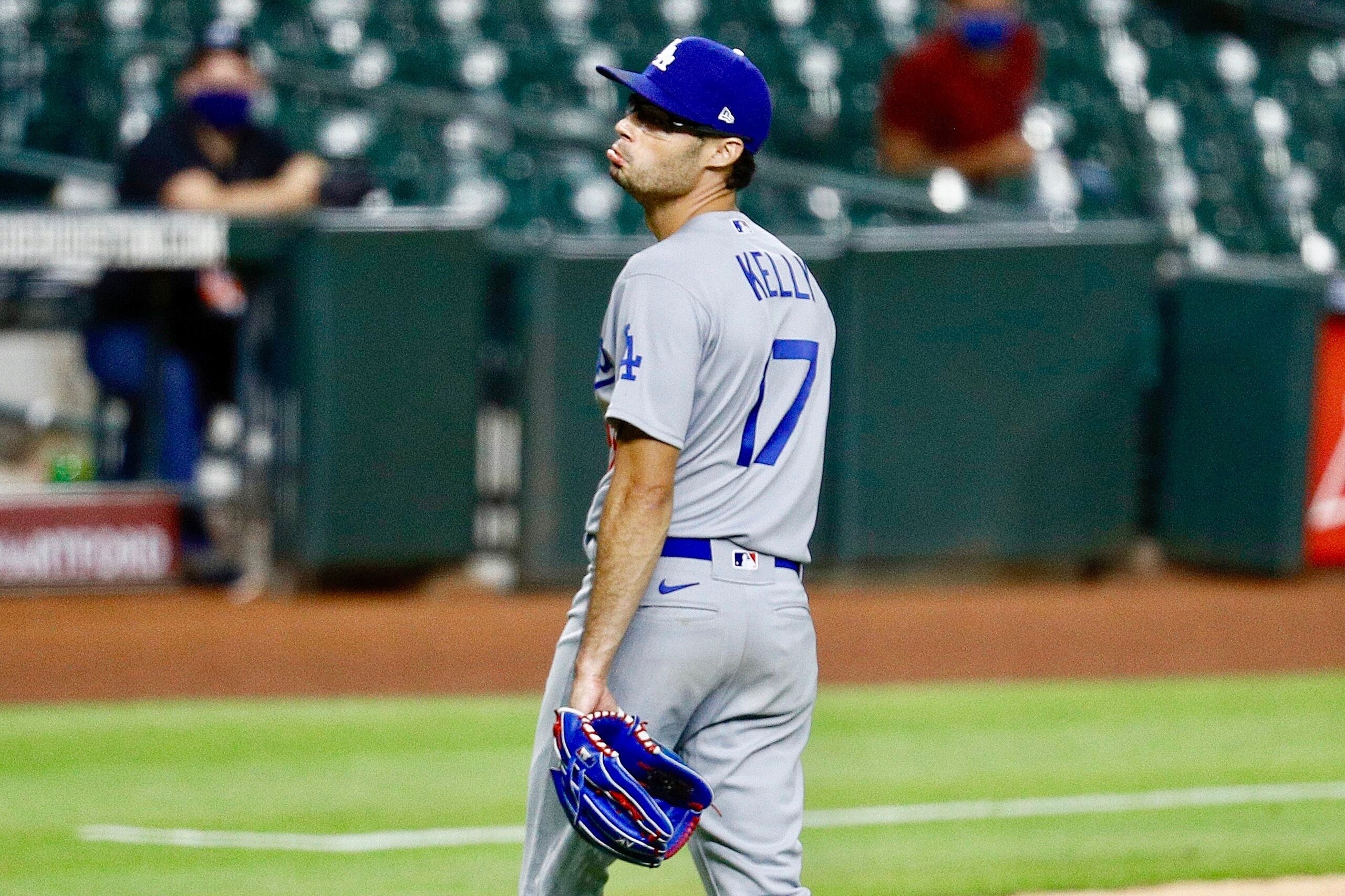 Los Angeles Dodgers relief pitcher Joe Kelly (17) yells back at Houston Astros' Carlos Correa (1) after the sixth inning of a baseball game Tuesday, July 28, 2020, in Houston. Both benches emptied during the exchange. (AP Photo/David J. Phillip)