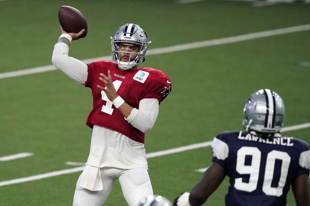 Dallas Cowboys quarterback Dak Prescott (4) passes against defender DeMarcus Lawrence (90) during an NFL football training camp practice in Frisco, Texas, Monday, Aug. 31, 2020. (AP Photo/LM Otero)