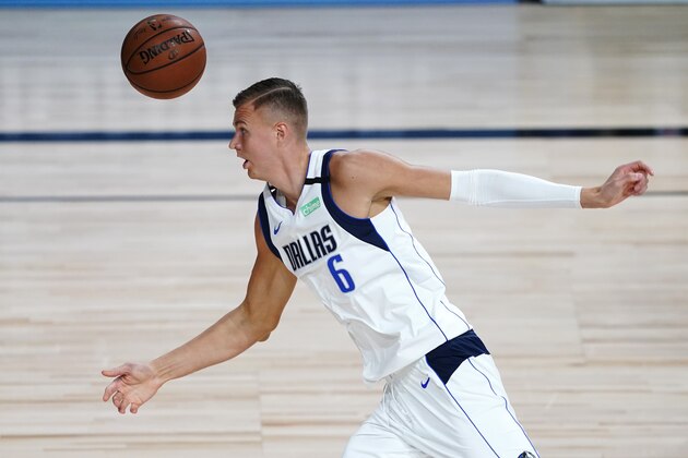 Dallas Mavericks' Kristaps Porzingis (6) chases after the ball during the first half of an NBA basketball game against the Los Angeles Clippers Wednesday, Aug. 19, 2020, in Lake Buena Vista, Fla. (AP Photo/Ashley Landis, Pool)