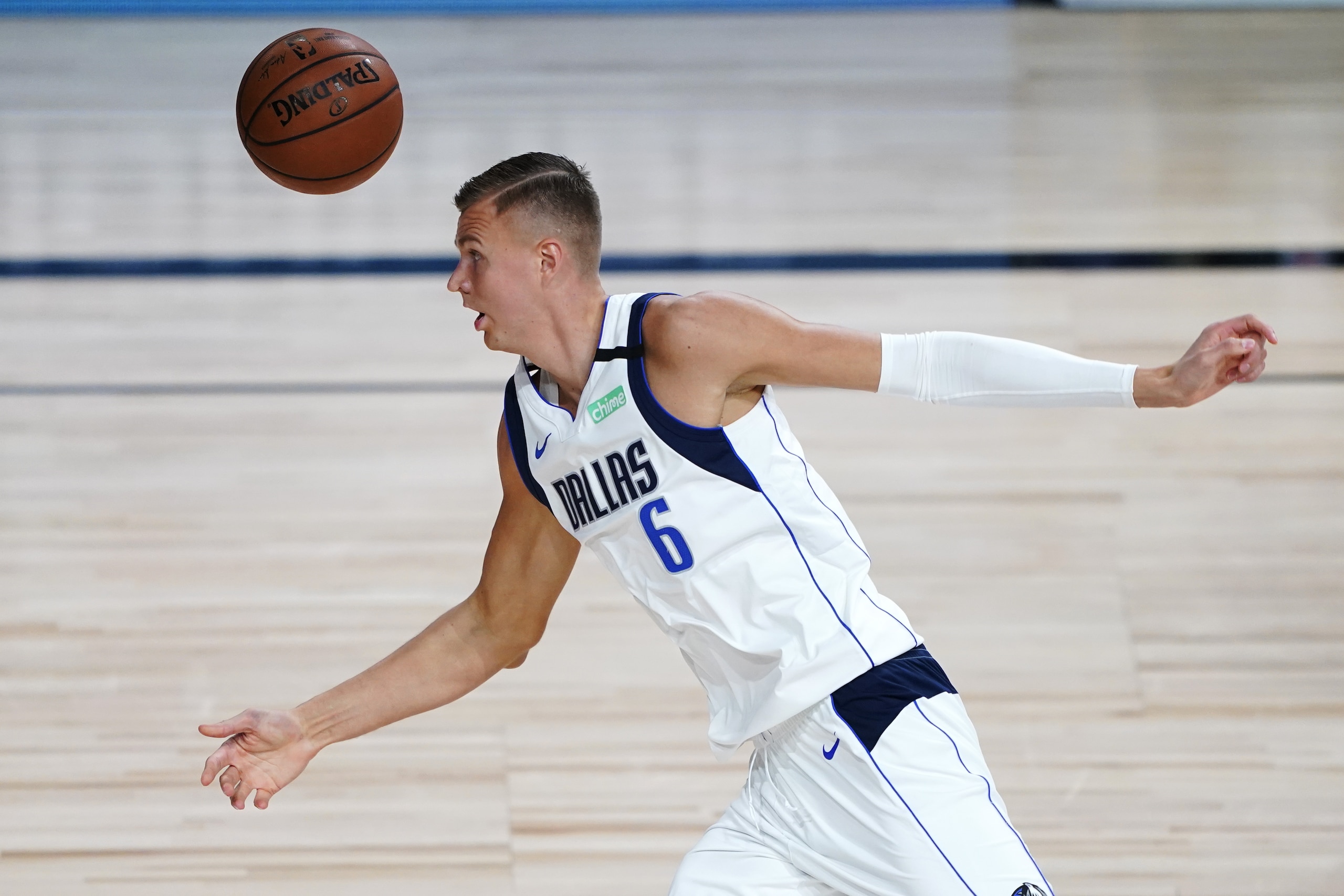 Dallas Mavericks' Kristaps Porzingis (6) chases after the ball during the first half of an NBA basketball game against the Los Angeles Clippers Wednesday, Aug. 19, 2020, in Lake Buena Vista, Fla. (AP Photo/Ashley Landis, Pool)