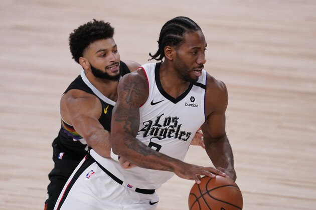 Denver Nuggets' Jamal Murray, left, reaches around for the ball as Los Angeles Clippers' Kawhi Leonard (2) looks for help during the first half of an NBA conference semifinal playoff basketball game Monday, Sept. 7, 2020, in Lake Buena Vista, Fla. (AP Photo/Mark J. Terrill)