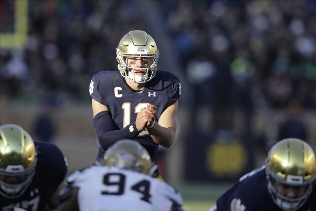 Notre Dame quarterback Ian Book (12) in action during the first half of an NCAA college football game against Navy, Saturday, Nov. 16, 2019, in South Bend, Ind.(AP Photo/Darron Cummings)