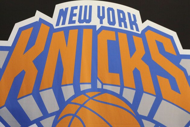 James Dolan, executive chairman of  Madison Square Garden, sits at a news conference next to the team logo where he introduced Phil Jackson as the new president of the New York Knicks, Tuesday, March 18, 2014 in New York. Jackson, who won two NBA titles as a player for the New York Knicks, also won 11 championships while coaching the Chicago Bulls and the Los Angeles Lakers. (AP Photo/Mark Lennihan)