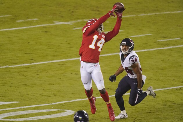 Kansas City Chiefs wide receiver Sammy Watkins (14) catches a pass over Houston Texans cornerback John Reid (34) in the first half of an NFL football game Thursday, Sept. 10, 2020, in Kansas City, Mo. (AP Photo/Charlie Riedel)