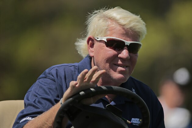 John Daly waves to golf fans as he drives down the 16th fairway during the first round of the PGA Championship golf tournament, Thursday, May 16, 2019, at Bethpage Black in Farmingdale, N.Y. (AP Photo/Andres Kudacki)