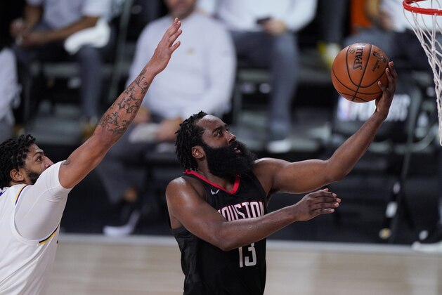Houston Rockets' James Harden (13) drives to the basket ahead of Los Angeles Lakers' Anthony Davis, left, during the second half of an NBA conference semifinal playoff basketball game Tuesday, Sept. 8, 2020, in Lake Buena Vista, Fla. (AP Photo/Mark J. Terrill)