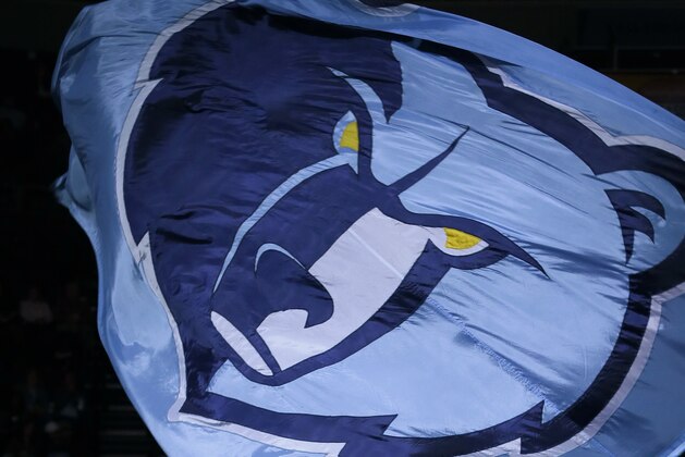Griz, the Memphis Grizzlies mascot, waves a banner displaying the team's logo before the first half of an NBA basketball game against the Phoenix Suns in Memphis, Tenn., Tuesday, Feb. 5, 2013. (AP Photo/Danny Johnston)