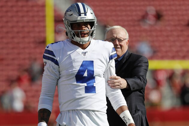 Dallas Cowboys owner Jerry Jones, right, stands behind quarterback Dak Prescott (4) as player warm up before an NFL preseason football game against the San Francisco 49ers in Santa Clara, Calif., Saturday, Aug. 10, 2019. (AP Photo/Josie Lepe)