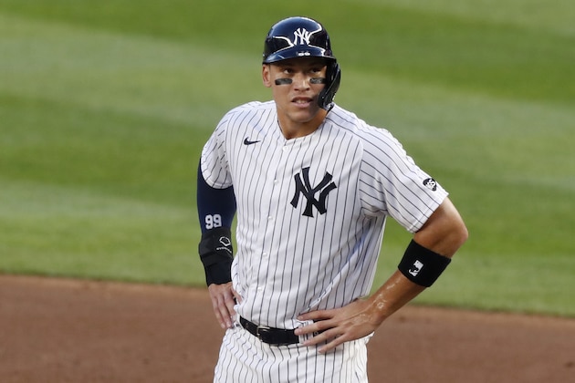New York Yankees right fielder Aaron Judge (99) stands on first after hitting a bloop single to short center field during the first inning of a baseball game against the Boston Red Sox, Sunday, Aug. 2, 2020, at Yankee Stadium in New York. (AP Photo/Kathy Willens)